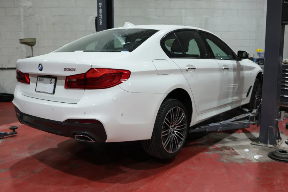 BMW 3 Series on the lift in the Golden Horse workshop in Al Quoz, Dubai